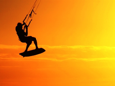 This dramatic image of a man kitesurfing (or, if you prefer, kiteboarding) at dusk was photographed by Jason Weeks of Cape Town, South Africa.